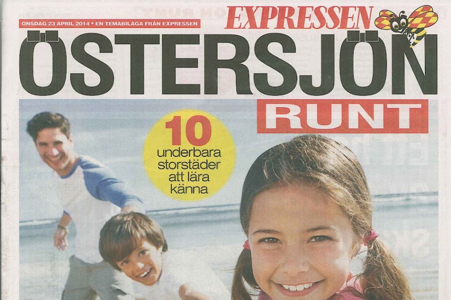 Tidningsomslag från Expressen med rubriken "Östersjön Runt". Bild visar en leende man och barn på en strand. Innehåller text: "10 underbara storstäder att lära känna". Publicerad onsdagen 23 april 2014.