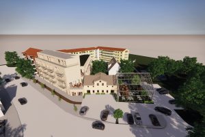 Modernt bostadskomplex i ljusa färger med flera våningar och balkonger. Glaspaviljong synlig framför huvudbyggnaden, omgiven av träd och parkerade bilar. Betongväg leder genom planen, kantad av träd.