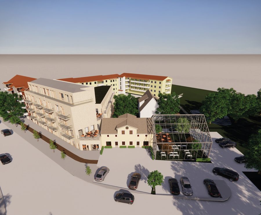 Modernt bostadskomplex i ljusa färger med flera våningar och balkonger. Glaspaviljong synlig framför huvudbyggnaden, omgiven av träd och parkerade bilar. Betongväg leder genom planen, kantad av träd.